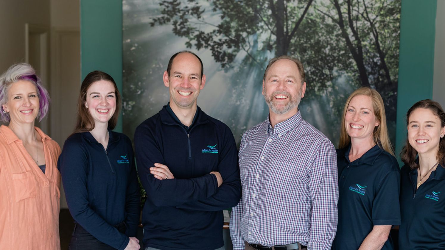 The clinic's chiropractors and staff in 2020, including Michael, Travis and Jen