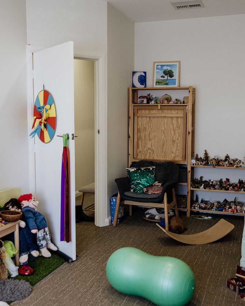 Play therapy room with toys and shelves